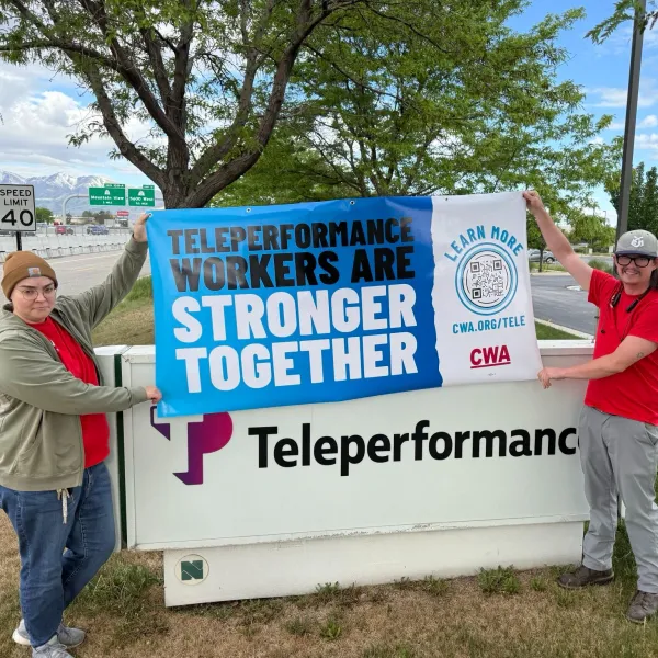 Workers with Teleperformance Banner